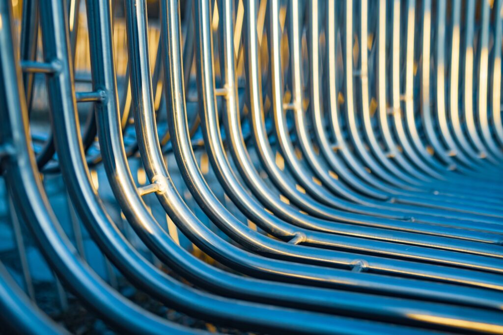 Close-up street bench metal pipes arranged parallel